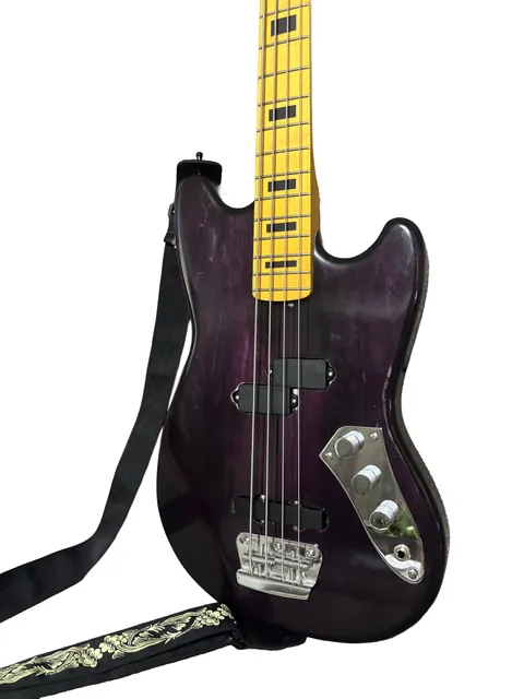 Purple bass with a yellow neck and a black strap, on a white background.