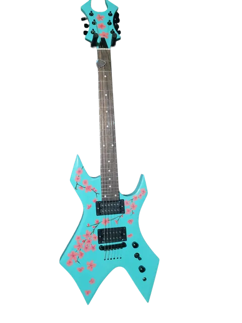 Pointed-body guitar painted turquoise with pink blossom artwork.
